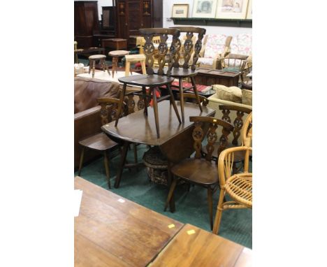 An Ercol drop leaf table and seven chairs