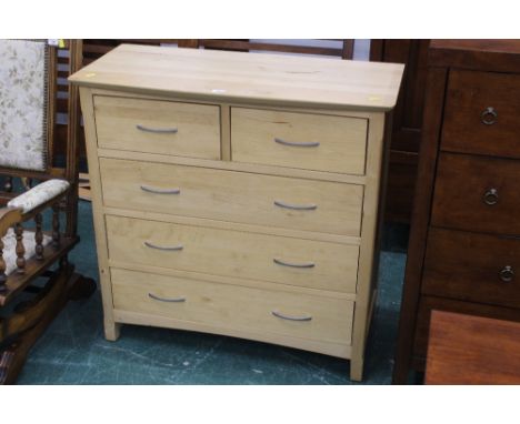 A modern light coloured 2/3 chest of drawers 