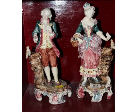 A pair of continental porcelain figures, modelled as a courting couple holding letters, 33 cm high (slight damage)