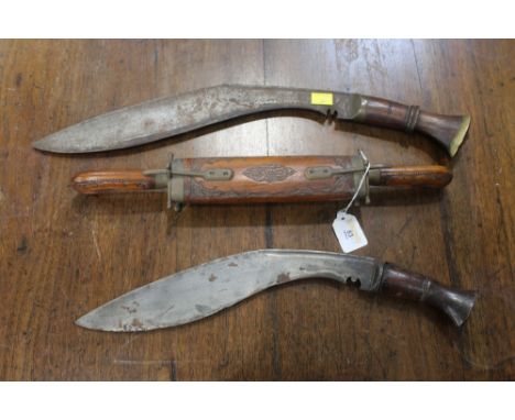 Two kukri knifes and a sheathed knife and fork  