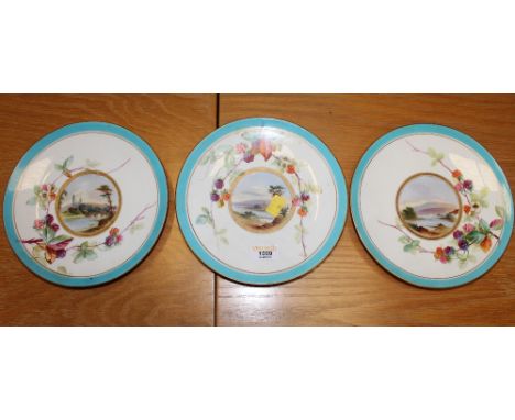 Three Victorian porcelain dessert plates, decorated with lake and river scenes respectively within borders, hand-painted with