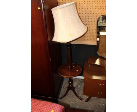 A mahogany standard lamp with shade