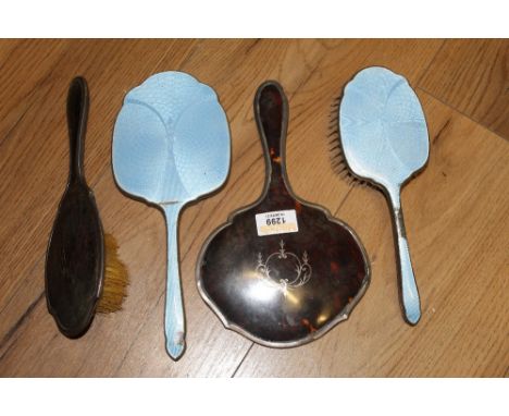 A George V silver mounted and tortoiseshell backed two part dressing table set, comprising hand mirror and hair brush, the mo
