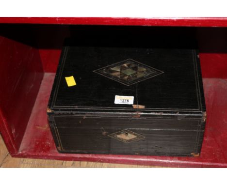 A Late Victorian ebonised wood sewing box, the lid inlaid with Mother of Pearl and with purple silk lined interior, 30 cm x 2