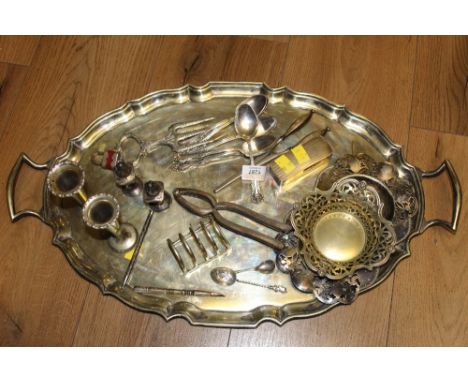 A Birks American silver tea spoon, with shaped terminal, five similar Rogers silver plated teaspoons, a pair of silver handle