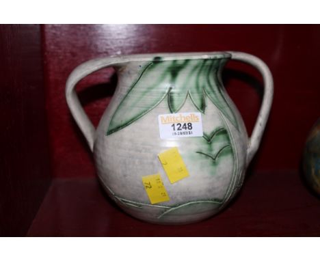 A Radford pottery two-handled vase decorated in green and mushroom and incised with abstract leaves, 15.5 cm high (slight chi