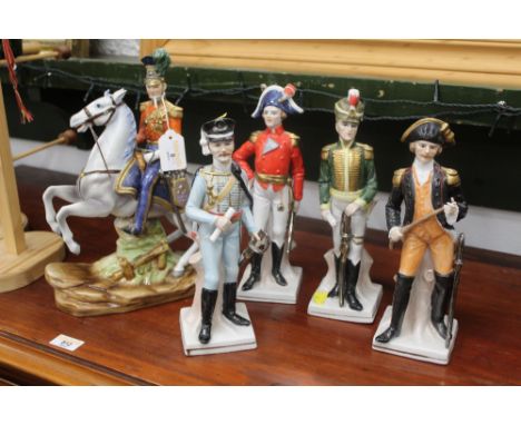 Five figurines in 19th century military uniforms, one mounted, horseman height 31 cm, individual figures height 25 cm




