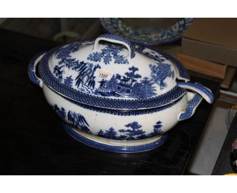 A 19th century blue and white pottery willow pattern oval two handled tureen and cover (repaired) with a blue and white potte