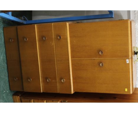 A 1960's light oak cupboard with four drawers below