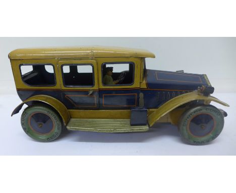 A clockwork tin-plate toy car, wheels marked Dunlop Cord, length 34cm