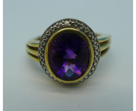 A silver gilt ring set with amethyst and diamond accents, R