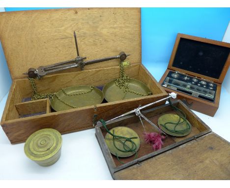 Two cased sets of weighing scales and weights including a set of brass conical weights