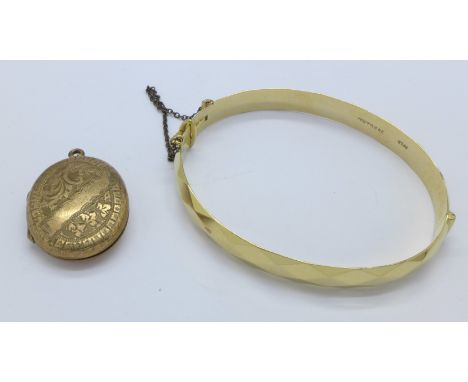 A rolled gold locket and a plated bangle