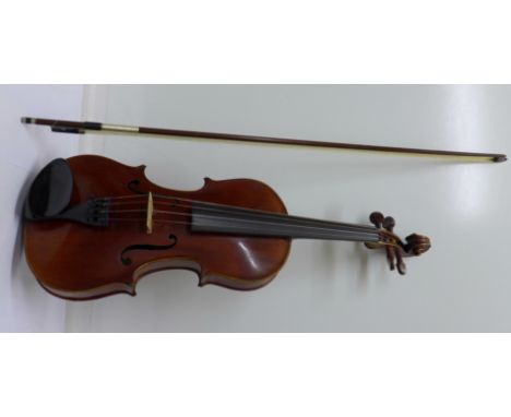 A German 19th Century violin and bow, cased, length of back 35cm, with insurance certificate