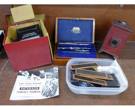 A toy tin plate magic lantern and assorted slides, a Patterson printer, lenses, etc.