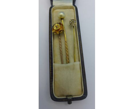 Three stick pins, one set with an old cut diamond and with worn hallmark, with a box