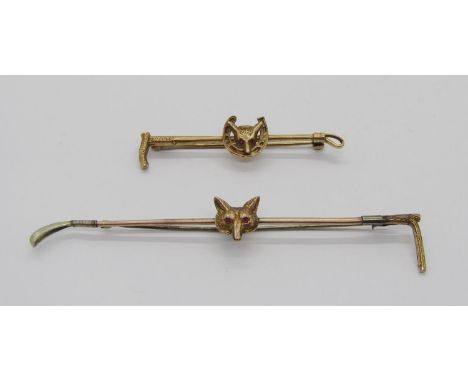 Two fox mask stock pins; a vintage 9ct ruby example, 5.5cm W approx, 4.7g and a yellow metal garnet example, 9.5cm W approx, 