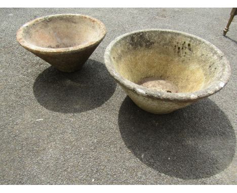 A weathered squat conical shaped cast composition stone planter 24 cm high x 52 cm diameter together with a similar smaller e
