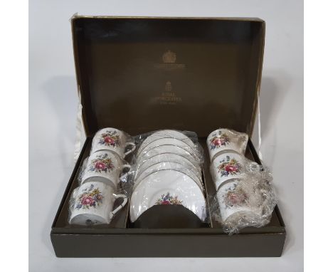 A boxed Royal Worcester set of six coffee cans and saucers with floral detail (original box, seemingly unused) 