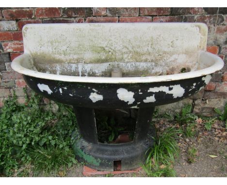 A large weathered painted cast iron and enamel water feature/basin of demi-lune form raised on a tapered and flared cast allo