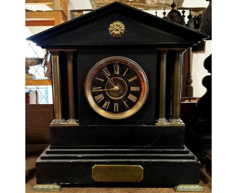 A Victorian black slate mantle clock with column supports and eight-day time piece, brass presentation plaque 