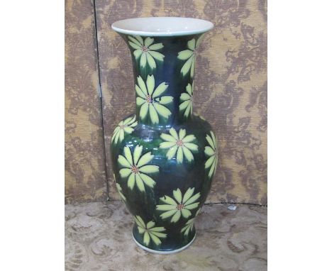 A large glazed ceramic floor standing vase, of baluster form with flared rim, with floral motifs, 77cm high.