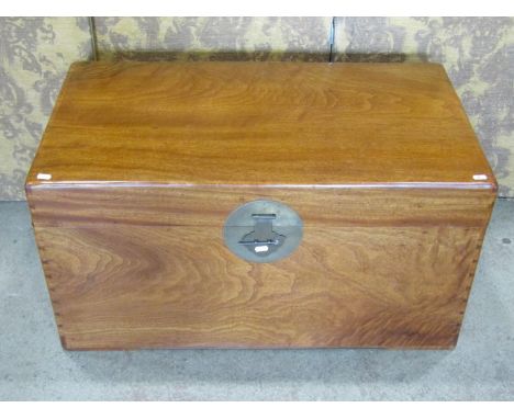 A large polished camphor wood trunk, with applied brass lock plate and brass carrying handles, 48cm high, 50 x 90cm 