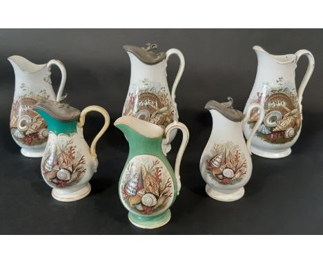 A collection of six 19th century Prattware jugs all with shell and coral detail, three with pewter mounts 
