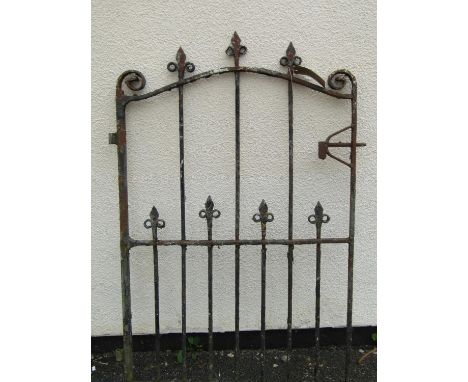 An old iron work pedestrian gate of arched form with open scroll finials and vertical bars with spear head finials, 125 cm hi
