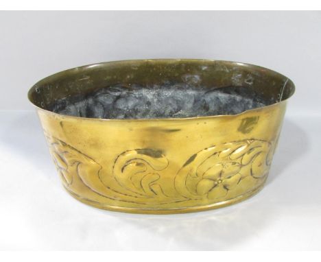 An oval Arts &amp; Crafts brass planter with embossed trailing flowers and riveted joins, no maker's marks, 32cm x 20cm