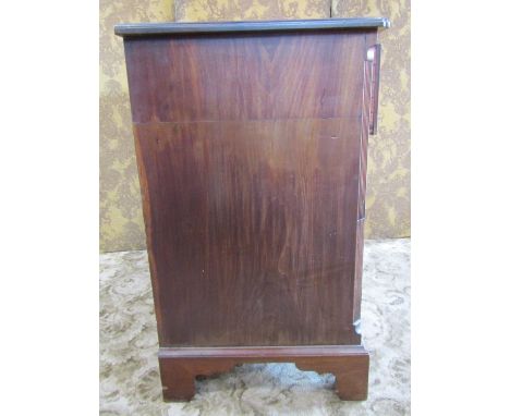 A 19th century mahogany chest of three long drawers, the first with divisional interior, fitted with brass handles and escutc