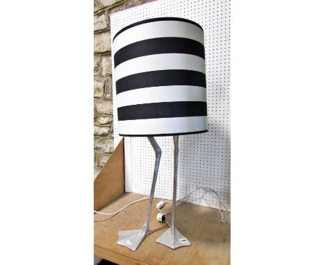 A Porta Romana duck leg lamp, with a black and white hooped shade, 84cm overall, (fitted with a continental plug)