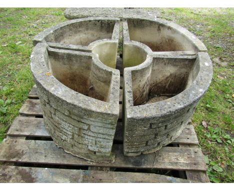 A Sandford cast composition stone  four sectional garden planter forming a circle with mock stone wall relief façade, 32 cm h
