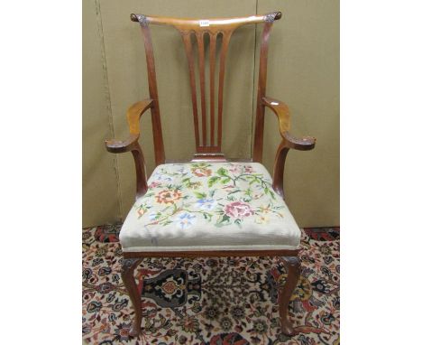 A 19th century satinwood elbow chair with pierced splat, scrolled arms with carved eagle terminals raised on shaped supports 