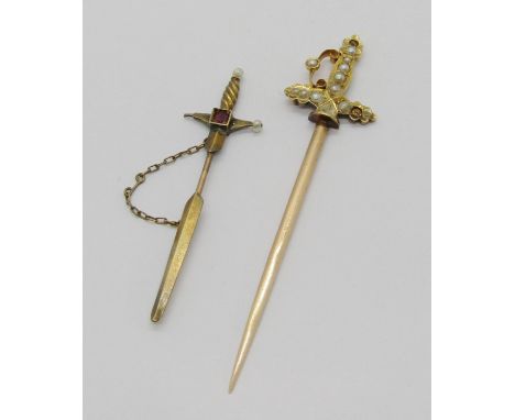 Two sword design jabot pins; a 15ct example set with pearls (a few vacant) and a smaller yellow metal example set with a spin