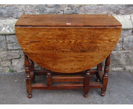 A small oak gate left table, 18th century and later, 74cm high, 83 x 114cm (maximum) 