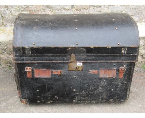 A large Edwardian domed fibre travelling trunk with leather strap work, brass escutcheon and studs / mounts, 63cm high, 82 x 