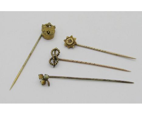 Four antique stick pins comprising a 15ct diamond chip example, a yellow metal rope twist knot pin, a gilt metal articulated 