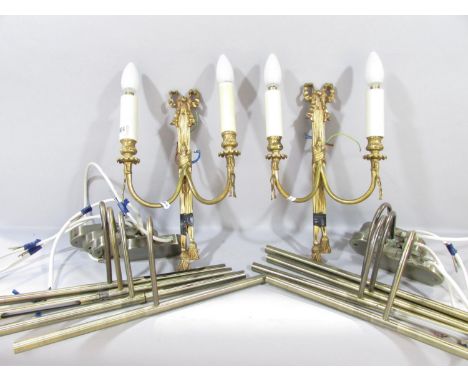 A pair of Regency style gilt swag and bow wall lights, a gold contemporary wall light with overlapping branches, and a select