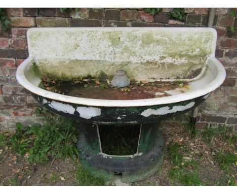 A large weathered painted cast iron and enamel water feature/basin of demi-lune form raised on a tapered and flared cast allo