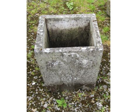 A weathered cast composition stone square tapered planter with raised relief detail, 34 cm square together with a novelty wea