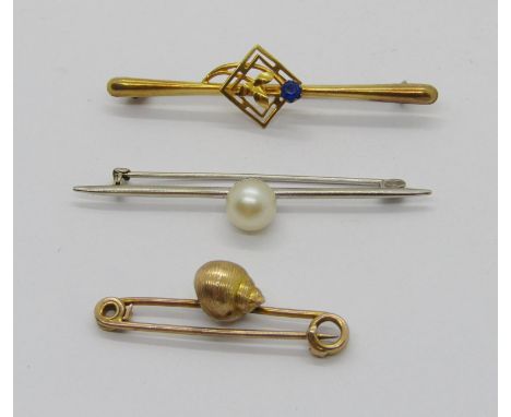Three antique 9ct brooches comprising a white gold example set with a pearl, a seashell design example (pearl setting vacant)