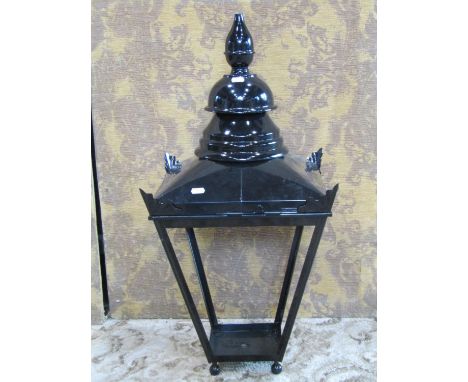 A contemporary hall lantern in the Georgian style with ebonised finish, 76cm high. together with a pair of candle stands (3)