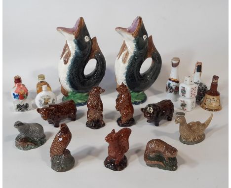 Two majolica leaping fish water jugs and a further collection of Beneagles Scotch Whiskey flasks in the form of animals, bear