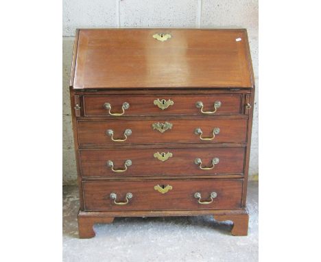 A Georgian mahogany bureau of neat proportions, the fall flap enclosing a partially fitted interior over four long oak lined 