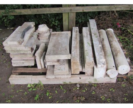 A weathered natural stone disassembled fireplace with egg and dart, carved borders and further carved detail (contained on a 