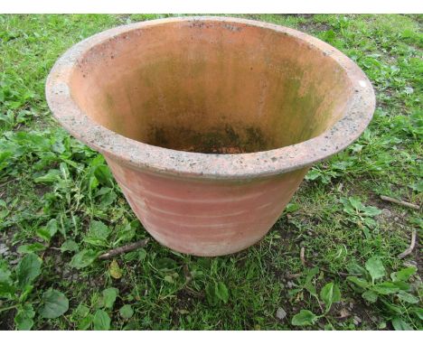 A large weathered terracotta planter of circular tapered form with flared rim 48 cm high x 72 cm diameter 
