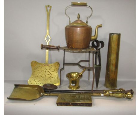 A collection of mainly 19th century brass ware, including a pestle and mortar, fire irons, trivet, a shell case, cribbage boa