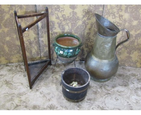A continental glazed terracotta olive jar on strand together with an oversized brass ewer / coal jug, a coopered jardiniere a