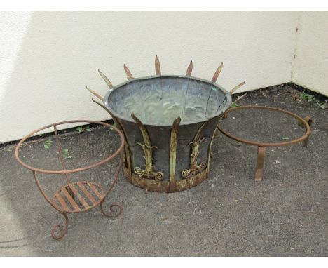 A large old weathered iron work planter of circular waisted form with copper liner leaf tendrils and scrolling framework, 59 